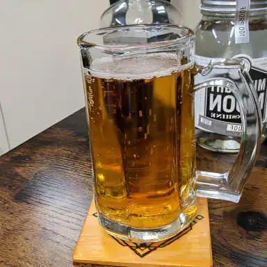A mug of complimentary craft beer being served to a client at MadMen Haircuts in Manhattan.