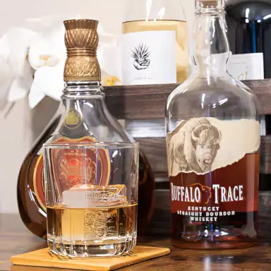 A bottle of bourban, a bottle of whiskey, and a glass of spirits served to a client at MadMen Haircuts in Manhattan.