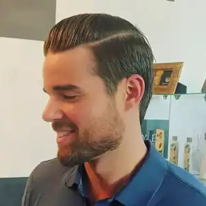 Profile of a young male client with a stylish, fresh haircut from MadMen Haircuts, showcasing the quality and modern styling of our men's haircuts in Midtown Manhattan.